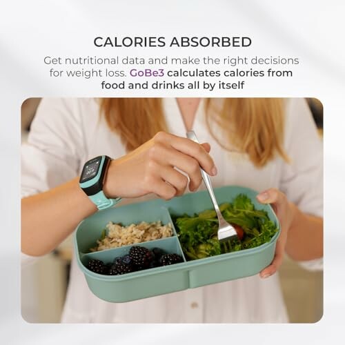Person using a calorie monitoring device while eating from a divided meal container.