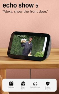 Echo Show 5 displaying a video feed on a wooden table.