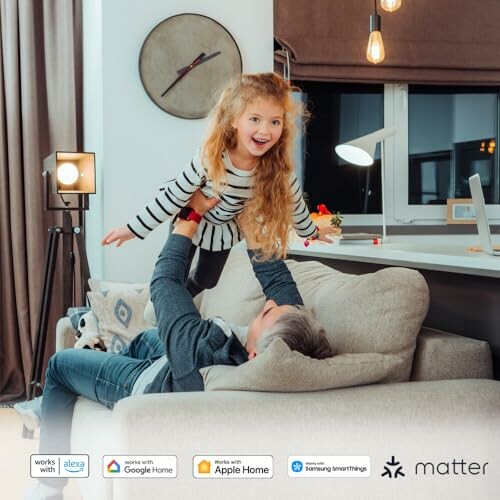 Father playing with daughter on a couch in a cozy living room.